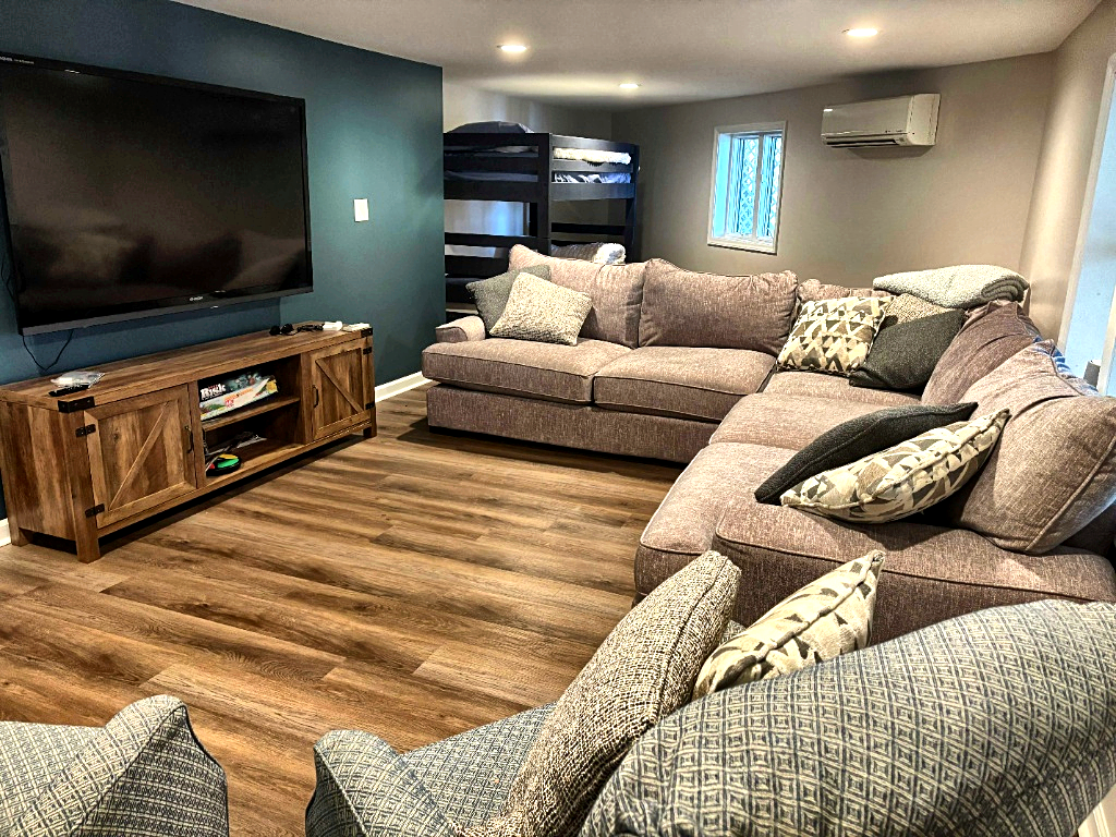 Basement lounge with large TV and sectional sofa